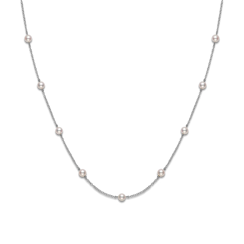 The Mikimoto 18K White Gold Akoya Cultured Pearl Station Necklace showcases exquisite Akoya cultured pearls evenly placed along a slender 18 karat white gold chain, set against a white background.
