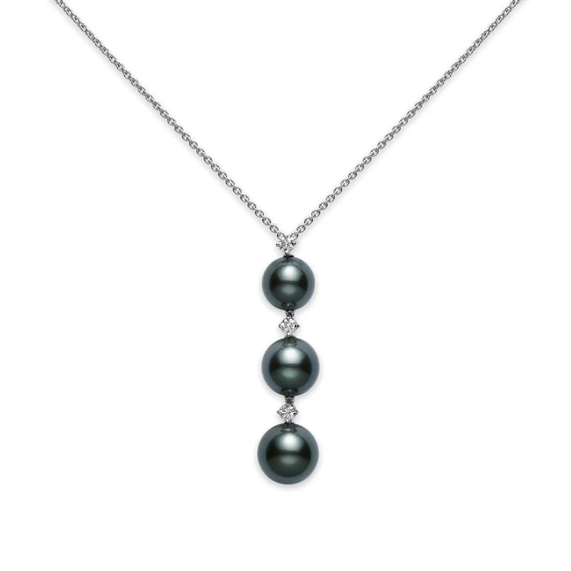 The Mikimoto Pearl Drop 18K White Gold Black South Sea Cultured Pearl with Diamond Necklace Pendant by Mikimoto showcases three vertically arranged black South Sea cultured pearls, each separated by pairs of sparkling diamonds and elegantly suspended from a delicate white gold chain.
