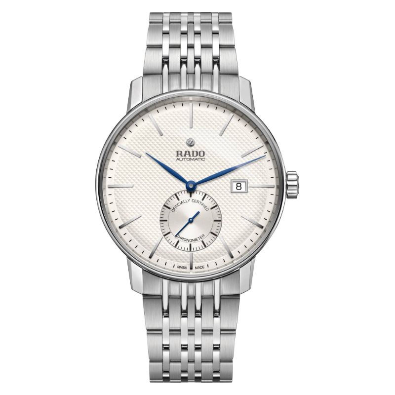 The RADO Coupole Classic Automatic 41mm Watch showcases a textured white dial adorned with blue hands and a date window positioned at 3 o'clock. It features an automatic movement, complemented by a subdial above the 6 o'clock marker, all safeguarded by sapphire crystal. The watch's polished steel bracelet and minimalist hour markers contribute to its sophisticated design.