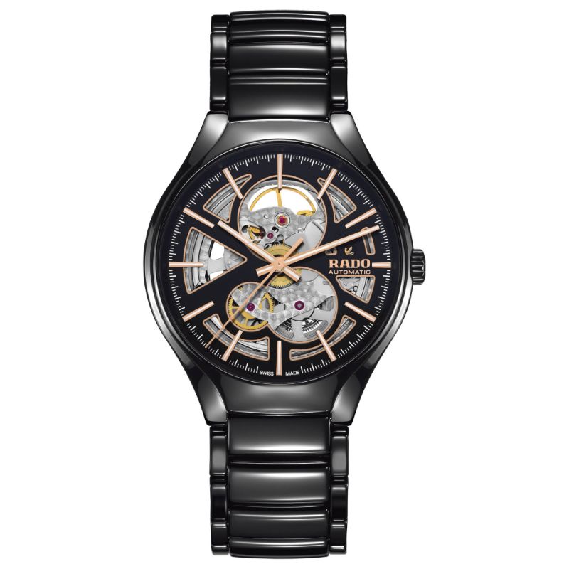 The RADO True Round Automatic Open Heart 40mm Watch is a luxury timepiece featuring a black ceramic band and a skeleton dial that reveals intricate mechanics with gold and silver details. The face of the watch displays gold hour markers and hands alongside the RADO brand name, highlighting its elegance with Swiss automatic movement.