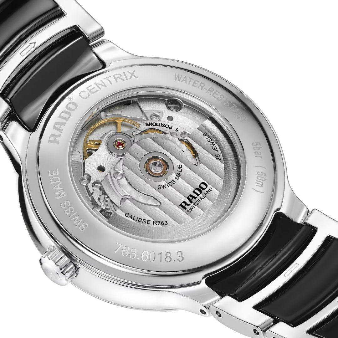 Close-up of the RADO Centrix Automatic Diamonds 39.5mm Watch’s transparent case back, revealing its automatic movement and engraved details such as water resistance and model number.