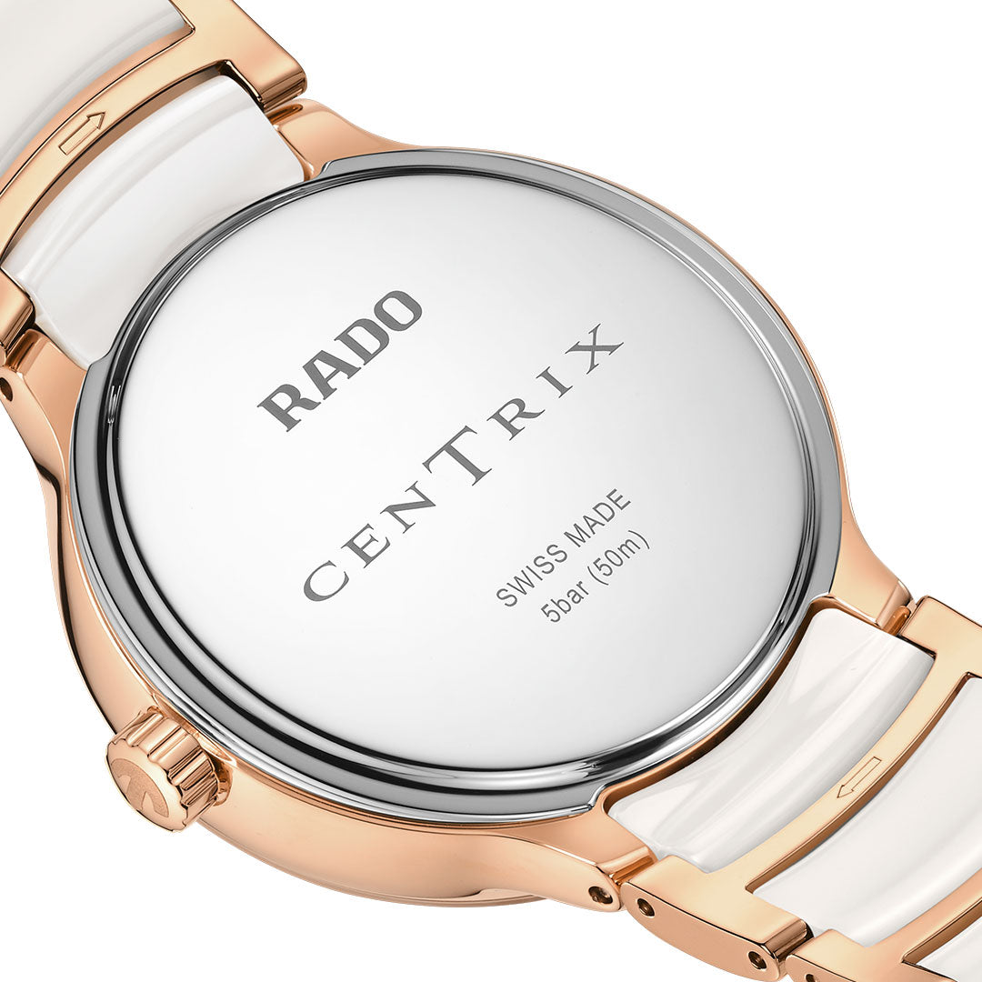 Close-up of the RADO Centrix Moonphase Quartz 35mm Watch back, showing a silver and gold case with white high-tech ceramic links and engraved "RADO CENTRIX SWISS MADE 5 bar 160m" text.