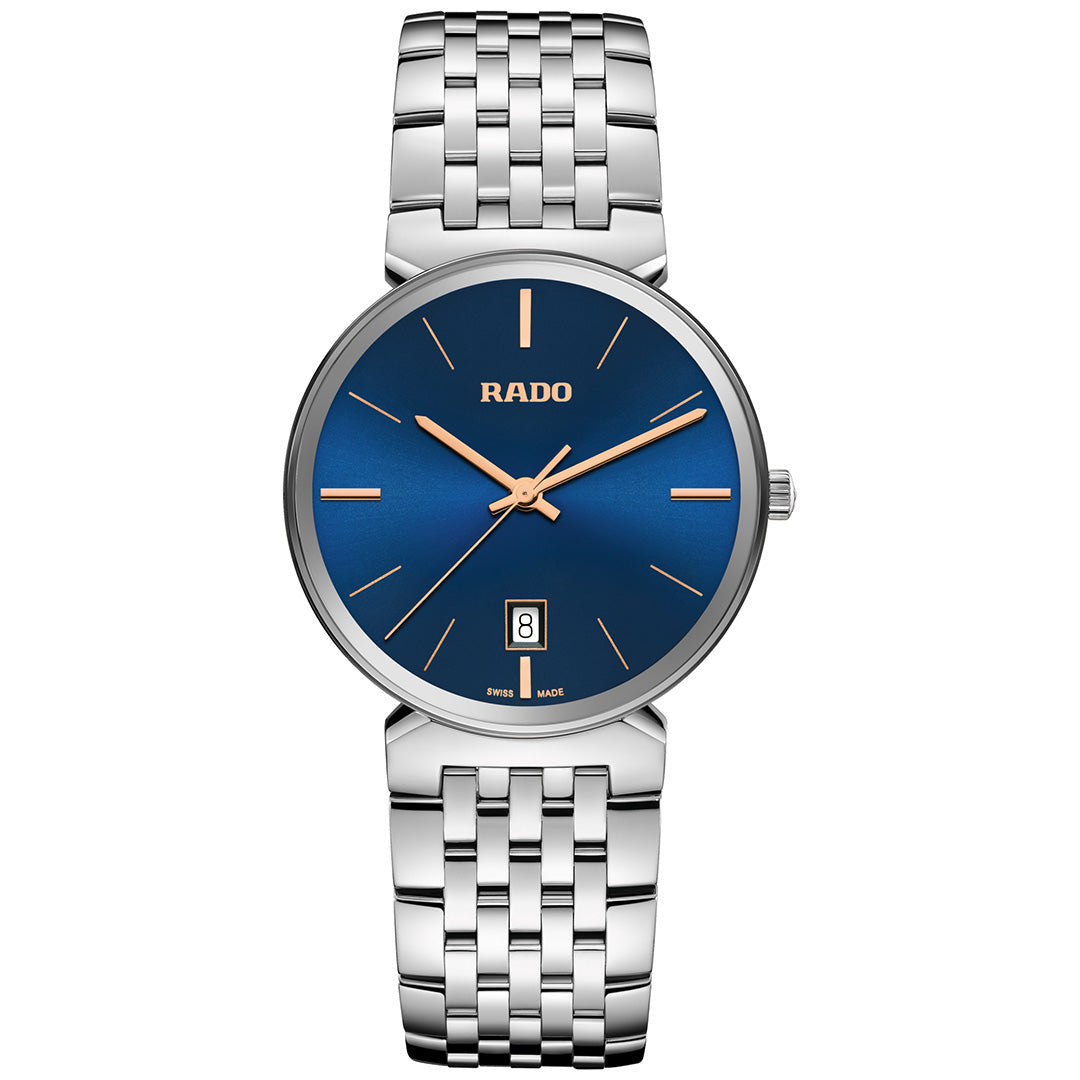 The RADO Florence Quartz 38mm Watch features a blue face, rose gold hands and markers, sapphire crystal, date at 6 o’clock, and a silver metal link band.