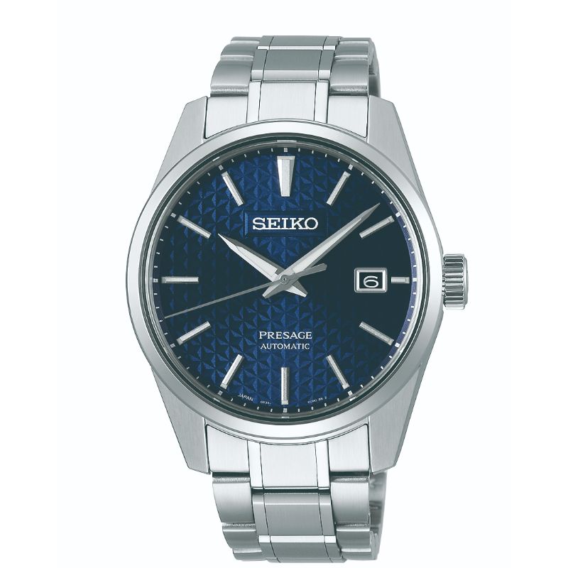 The Seiko Presage Prestige Line Automatic with Manual Winding 39.3mm Watch showcases a Japanese aesthetic with its textured blue dial adorned with silver hour markers. This masterpiece of traditional craftsmanship features a date window at the 3 o'clock position and is beautifully encased in a stainless steel bracelet.