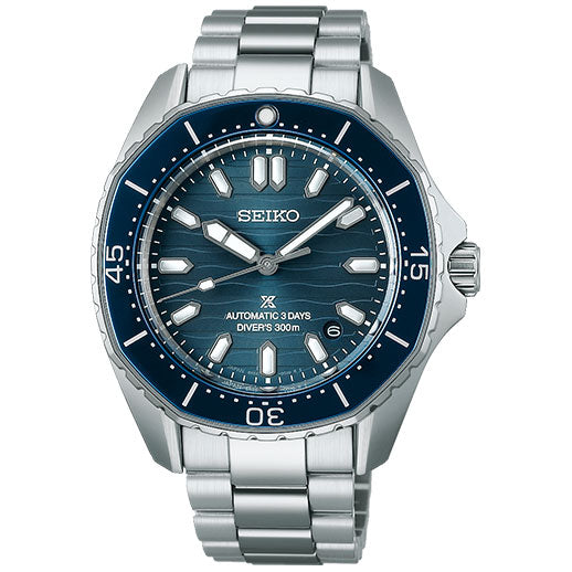 The Seiko Prospex Sea Automatic with Manual Winding 41.3mm Watch features a blue dial, silver markers and hands, date window at 4 o'clock, stainless steel bracelet, blue bezel with white markings, and is water resistant to 300 meters.