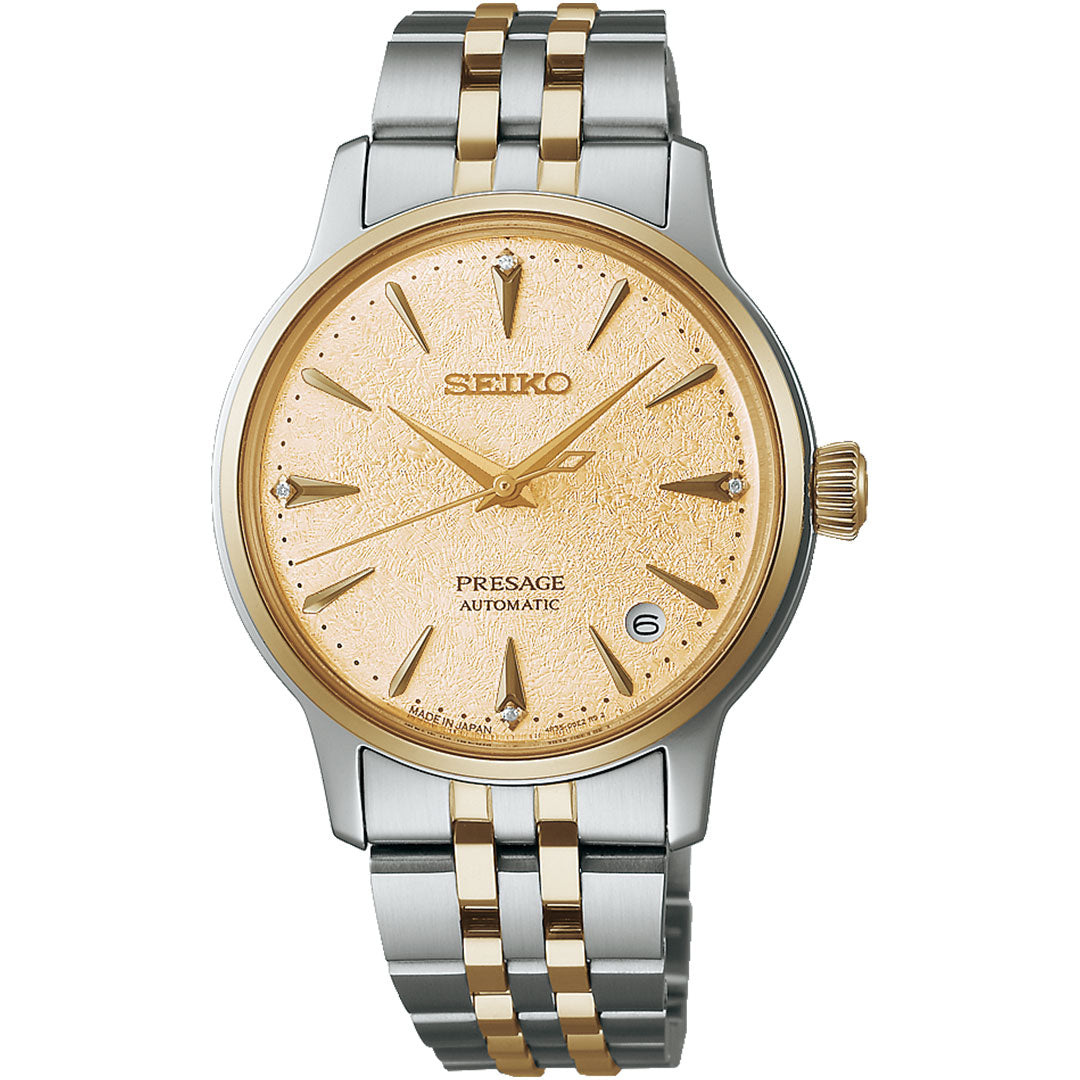 The Seiko Presage Cocktail Time Automatic with Manual Winding 34mm Watch features a gold textured dial, gold-tone hour markers and hands, and a silver and gold stainless steel case and bracelet with a date window at 3 o’clock.