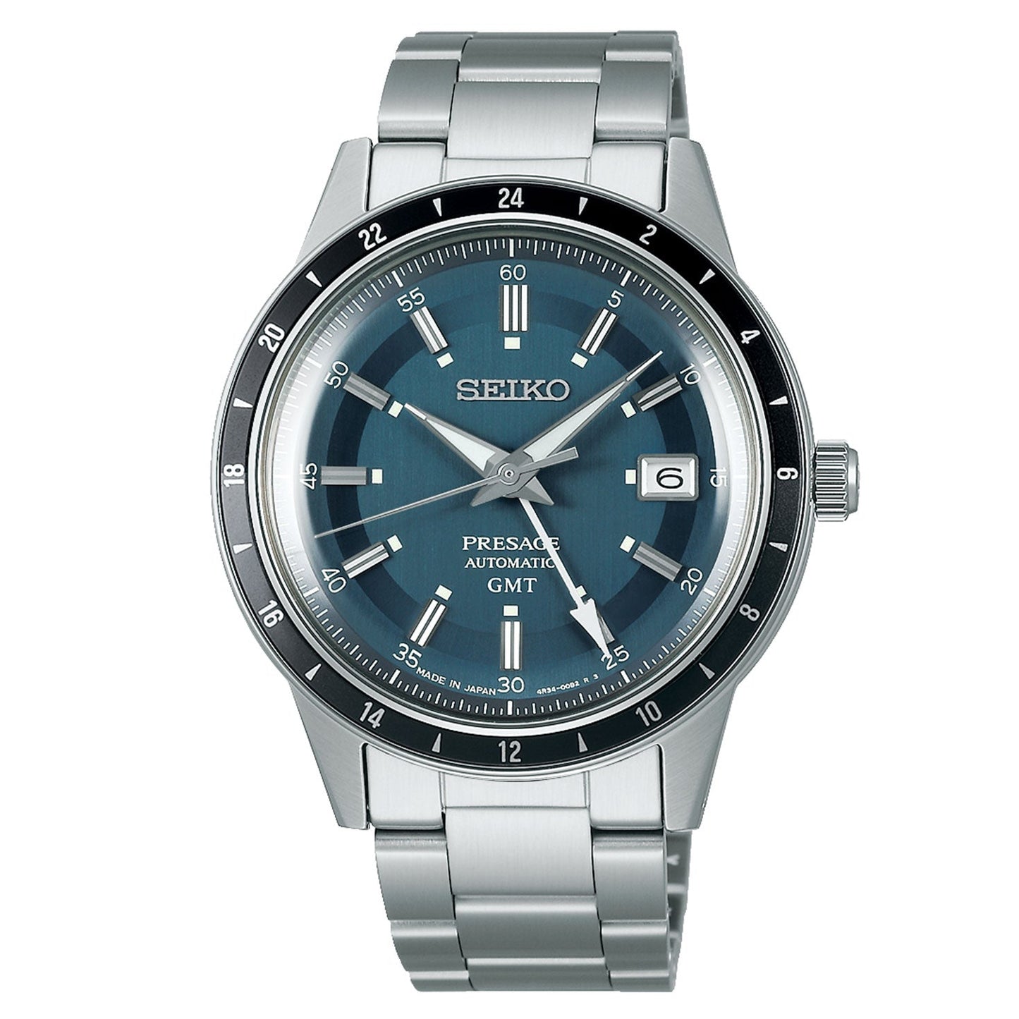 A Seiko Presage Style 60's Automatic watch, featuring a striking blue dial and powered by an automatic movement with manual winding. The watch showcases silver hour markers, a date window at 3 o'clock, and a contrasting black bezel with white accents. Its polished finish provides a sophisticated touch to the stainless steel bracelet and refined case.
