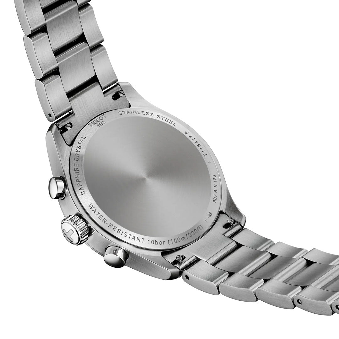Close-up of the back of a Tissot CHRONO L Quartz 42mm watch with a metal link band. The case back displays "STAINLESS STEEL," "SAPPHIRE CRYSTAL," Swiss technology, and water resistance details.