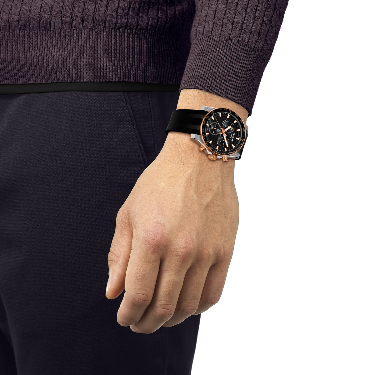 A Tissot Supersport Chrono Quartz 42mm Watch with a black dial and rose gold-tone accents on a black silicone strap, worn on a wrist.