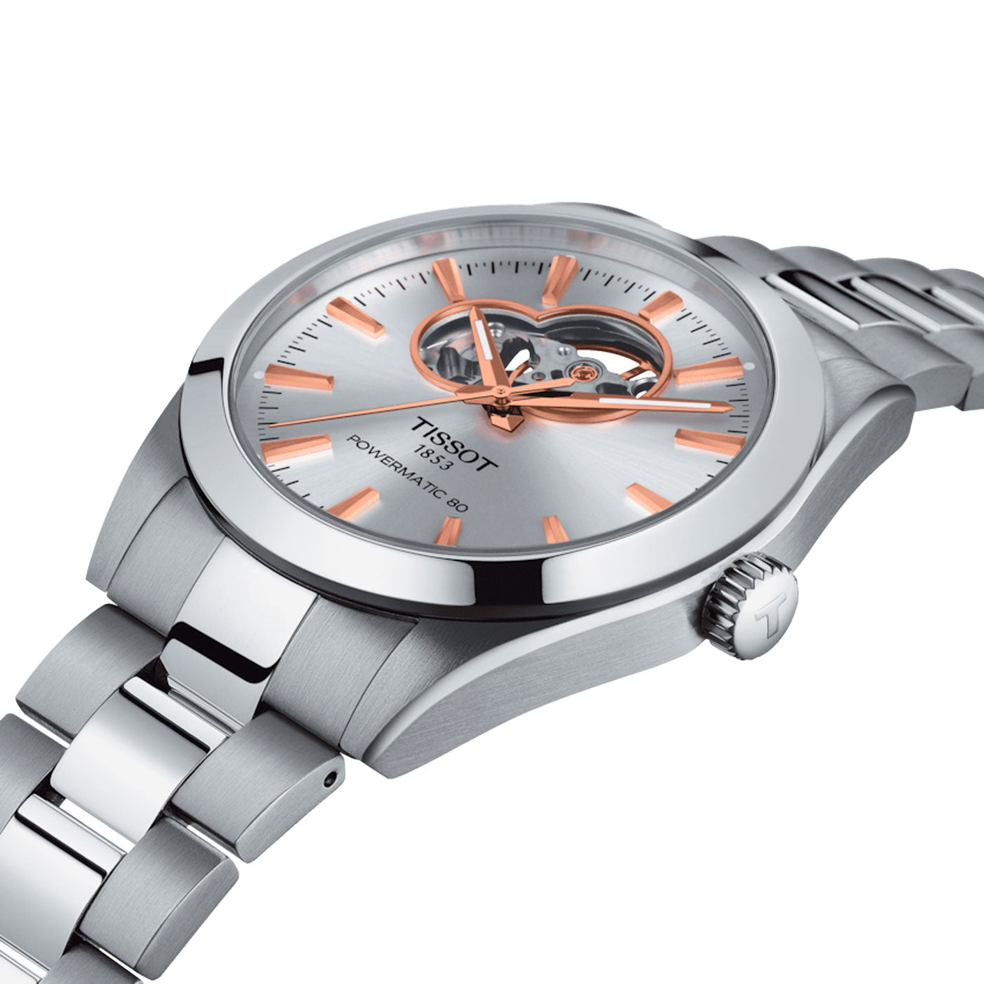 Close-up of a Tissot Gentleman Powermatic 80 Automatic Open Heart 40mm Watch. This Swiss Automatic Movement timepiece from Tissot showcases a silver face with rose gold accents, an open heart feature on the dial, and a 316L stainless steel bracelet. The crown is adorned with the Tissot logo.