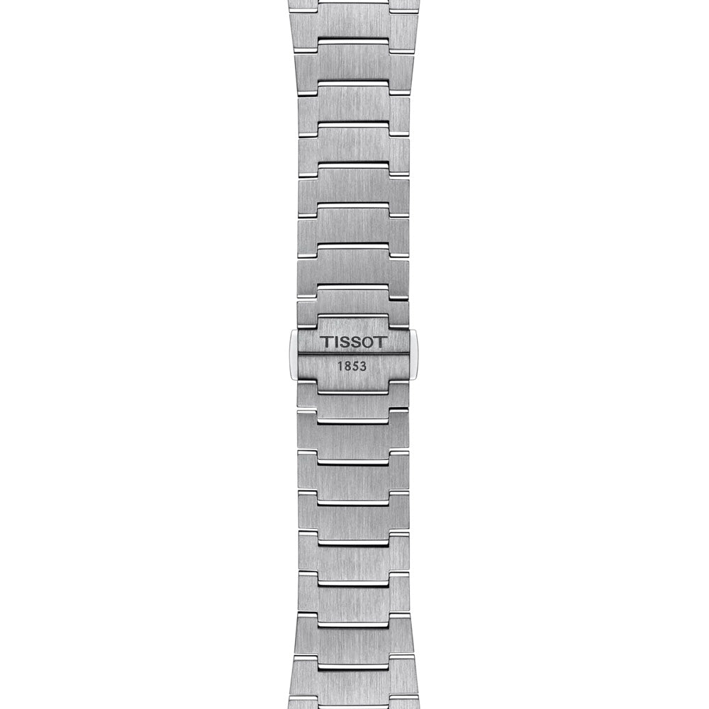 A close-up view of the Tissot PRX Gradient Powermatic 80 Automatic 40mm Watch reveals a silver metallic bracelet showcasing interlocking links and a clasp. The sleek design is enhanced by the engraved "Tissot" brand with "1853." Combined with an elegant gradient dial, this watch embodies both modernity and timelessness.