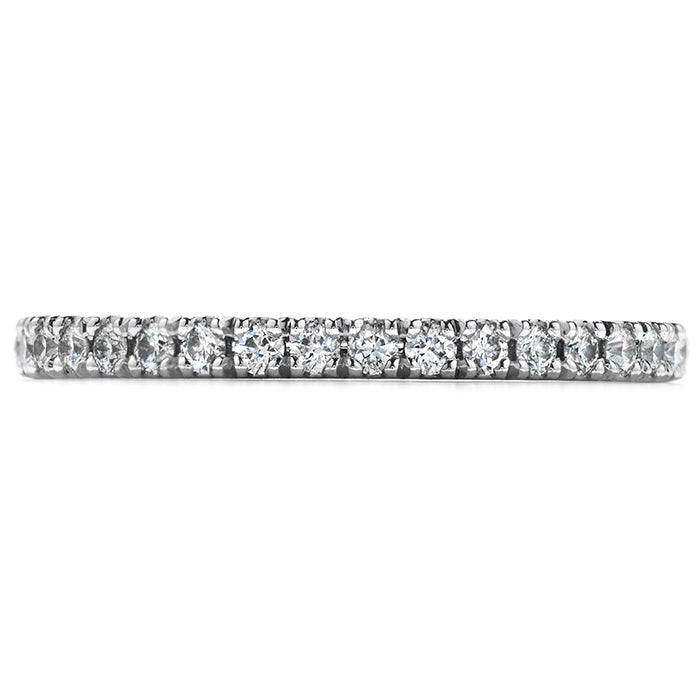 The "Hearts On Fire Transcend Platinum Round Brilliant Diamond Anniversary Ring" by Hearts on Fire showcases a continuous row of small round diamonds set in a polished platinum band, representing eternal love and commitment. Ideal as an anniversary ring, its shine embodies an elegant and timeless design.