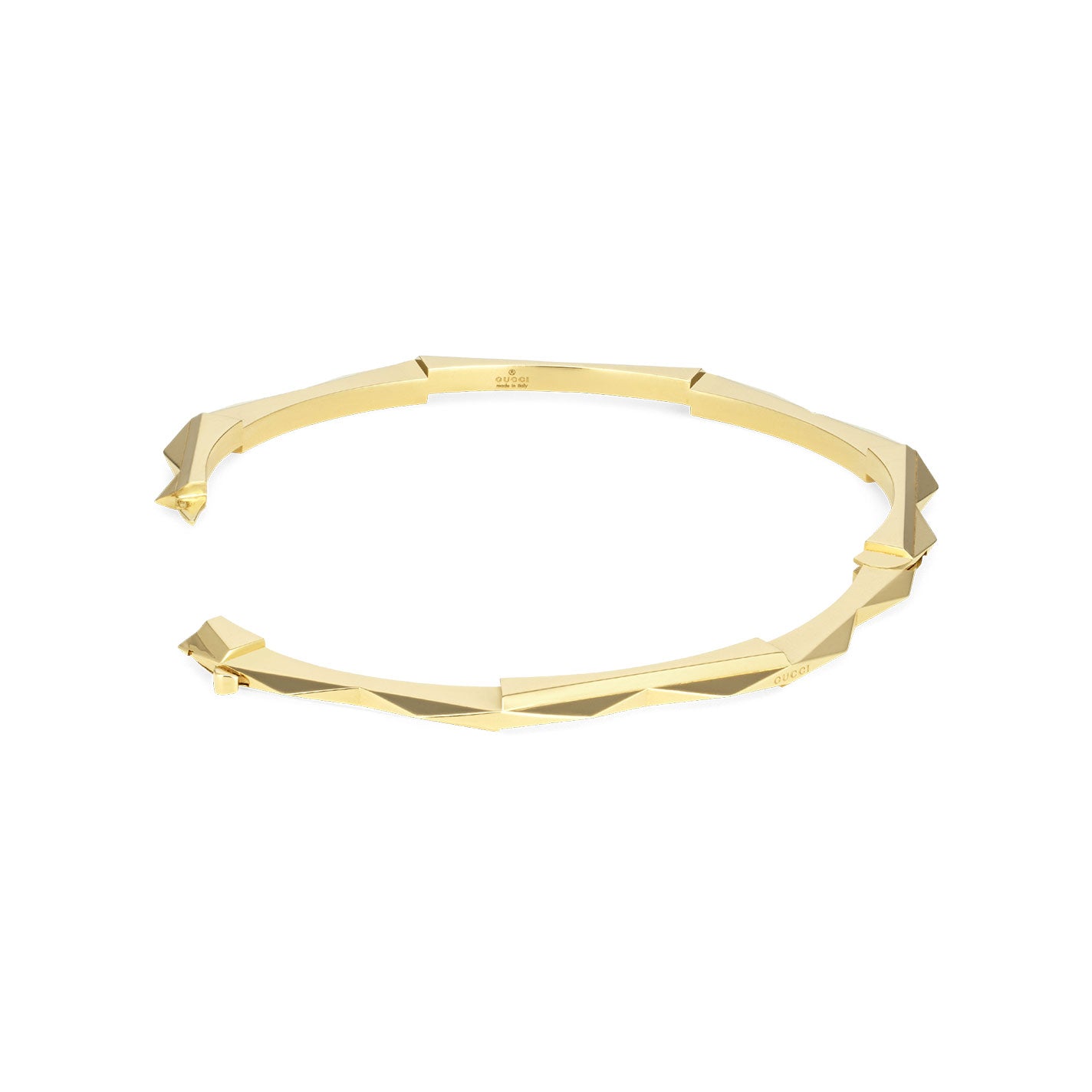 The Gucci Link to Love 18K Yellow Gold Studded Bangle by GUCCI Fine Jewellery features a striking geometric angular design. This polished bracelet showcases a sophisticated hinged clasp, adding a luxurious touch to any ensemble.