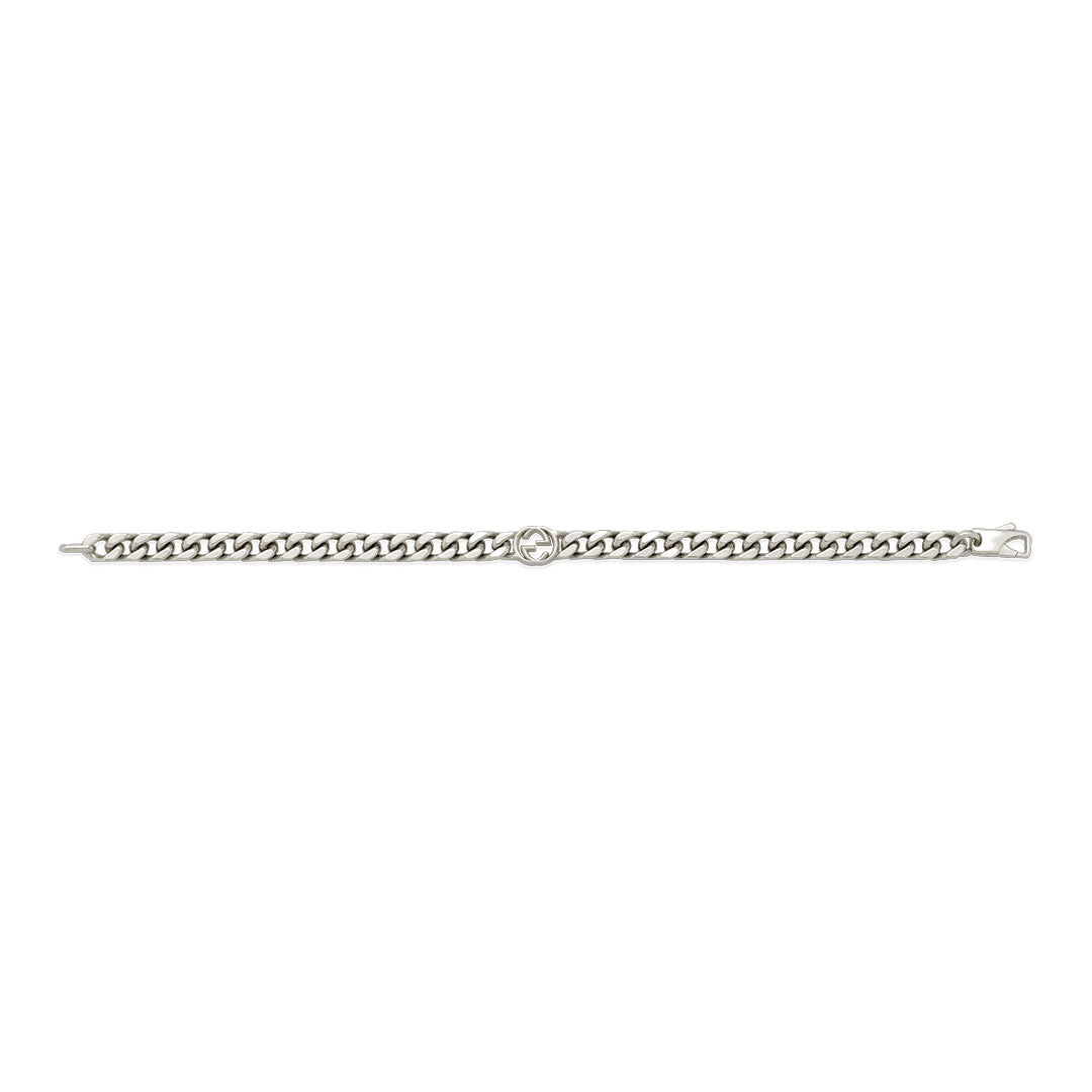 The Gucci Interlocking G Sterling Silver Bracelet by GUCCI Fine Jewellery features a curb link design and circular emblem with the signature Interlocking G, adding timeless elegance to any look.