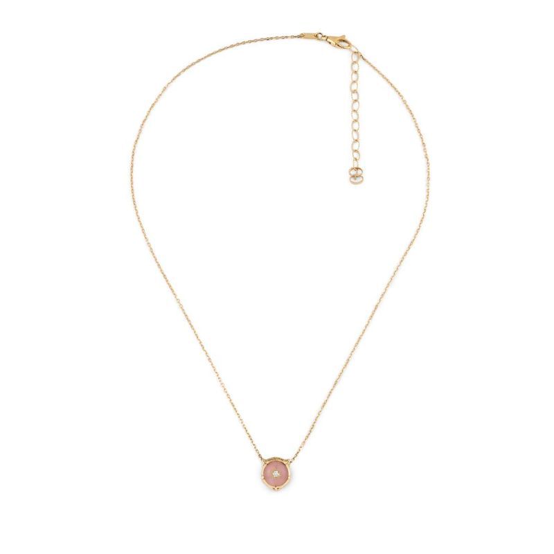 A luxurious Gucci Feline Head necklace by GUCCI Fine Jewellery, crafted from 18K yellow gold, features a small circular pink opal pendant at its center. This elegant piece includes an adjustable chain with a lobster clasp, adding sophistication to any outfit.