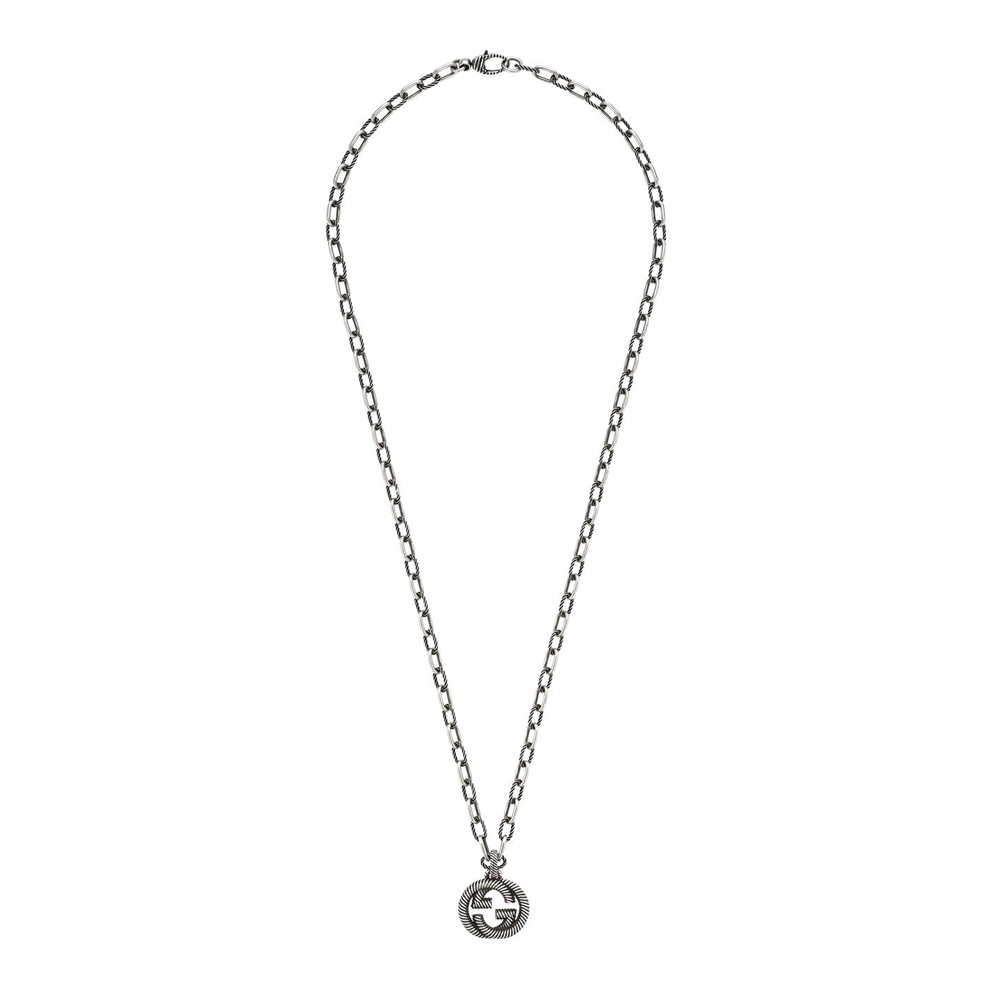 A Gucci necklace featuring large links and a sterling silver pendant with an interlocking G design at the center, crafted by GUCCI Fine Jewellery.