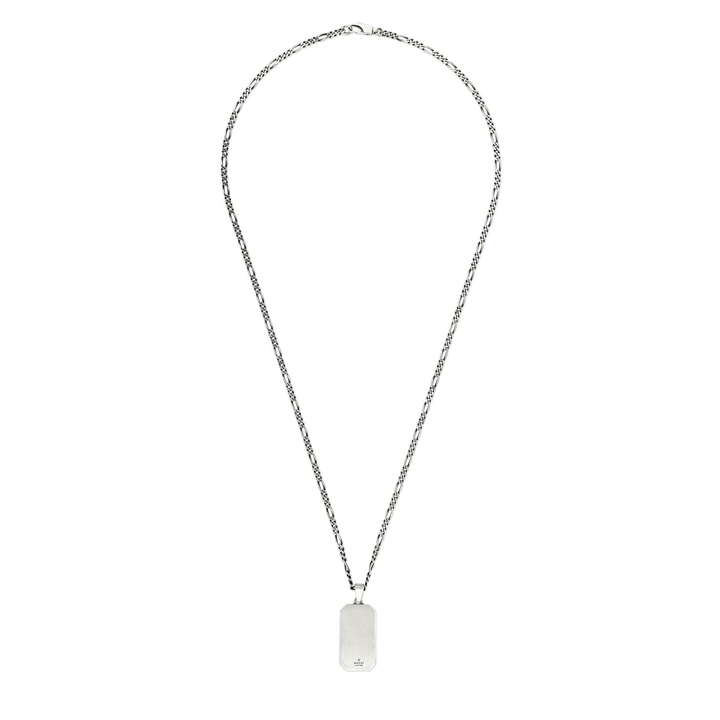 A Gucci GG and Bee engraved sterling silver necklace pendant with a long chain, featuring a subtle maple leaf design. The background is plain white, providing a clean and crisp appearance.