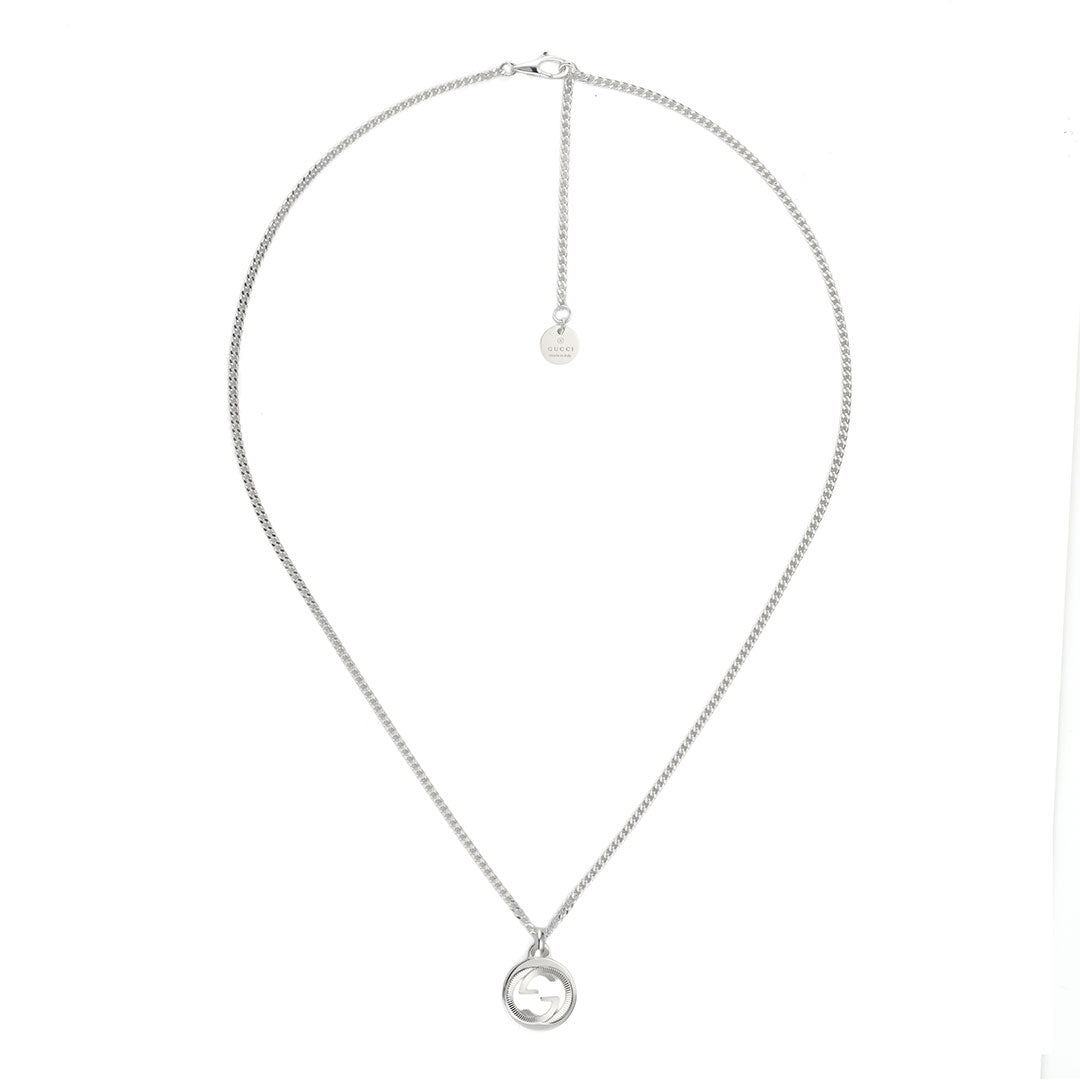 Certainly! Here is the rewritten sentence using your product data: A sterling silver necklace from GUCCI Fine Jewellery, featuring the iconic Interlocking G pendant in a round design with elegant Guilloché-style detailing. The chain includes an extender and a small circular tag near the clasp.
