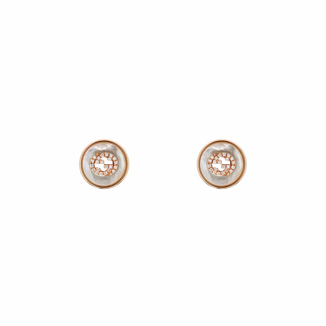 The Gucci Interlocking 18K Rose Gold Diamond Stud Earrings from GUCCI Fine Jewellery are a pair of exquisite circular earrings in gold and white, featuring intricate central detailing and accented with a touch of rose gold. The design is set against a plain white background, radiating elegance and sophistication.