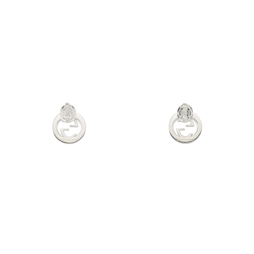 Gucci Interlocking G Sterling Silver Stud Earrings by GUCCI Fine Jewellery, featuring an elegant interlocking double G logo with intricate guilloché cut-out detailing, presented on a white background.