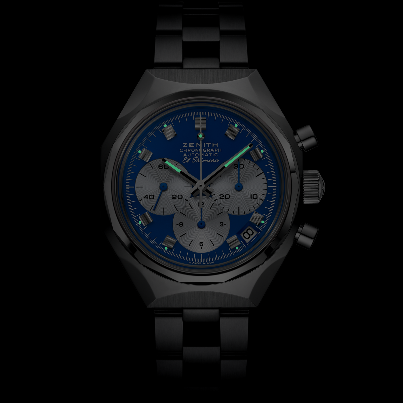 The Zenith Defy Chronograph USM - Genetian Blue features a black metal case and band, blue dial, three silver subdials, silver hands and markers, with a luminous face that stands out against the dark background.