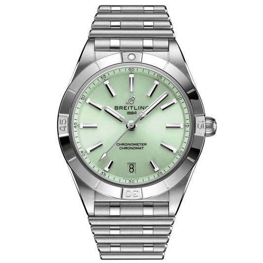 The BREITLING Chronomat Automatic 36 watch features a sophisticated silver metal band paired with a mint green dial. It includes silver hour markers, hands, and a date window at the 6 o'clock position, all harmonizing with its engraved bezel. This COSC-certified chronometer prominently showcases the Breitling logo along with the year "1884.