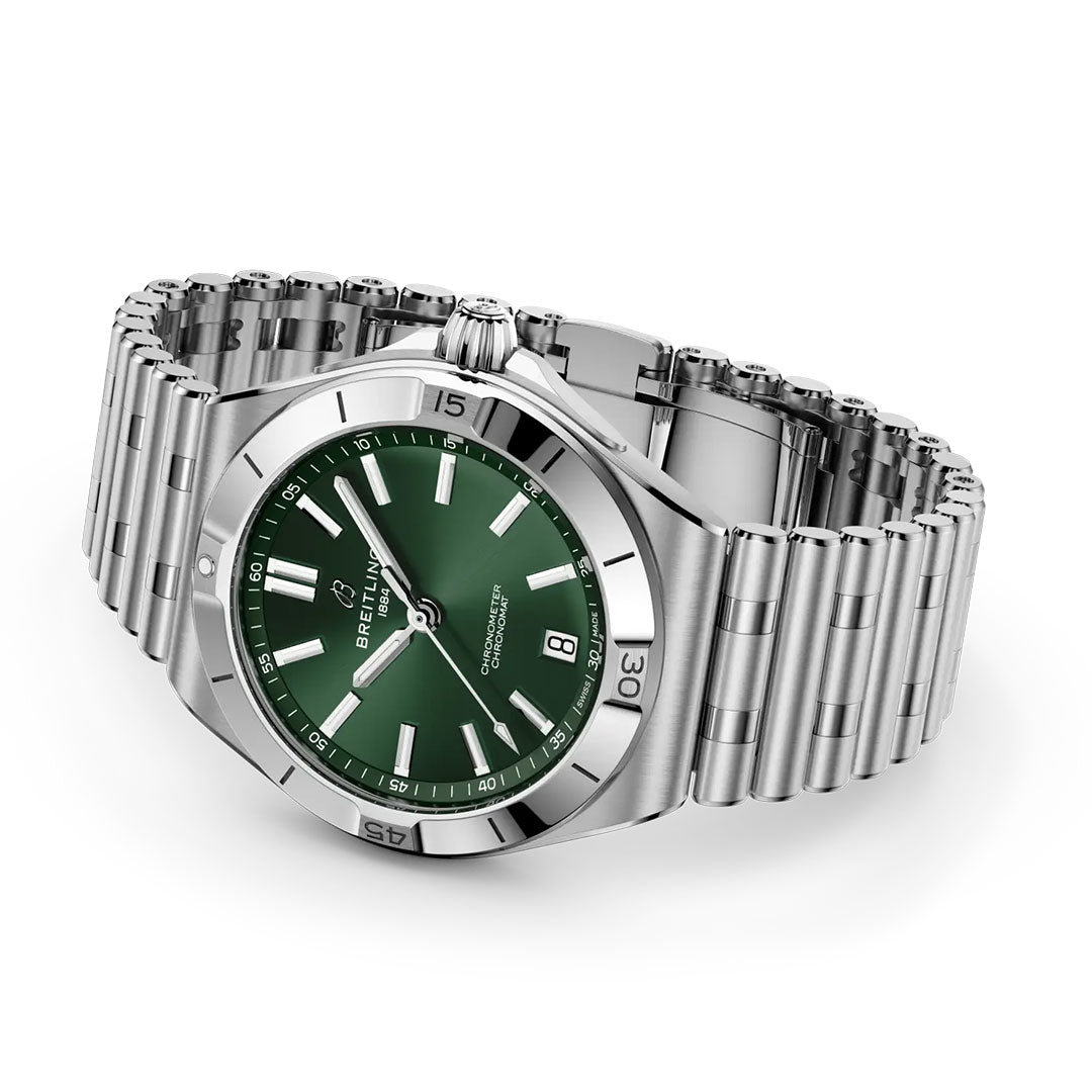 The BREITLING Chronomat B31 40 is a COSC-certified luxury sports watch with a green dial, silver hour markers, date at 6 o’clock, unidirectional bezel with minute markers, polished stainless steel bracelet, and case.