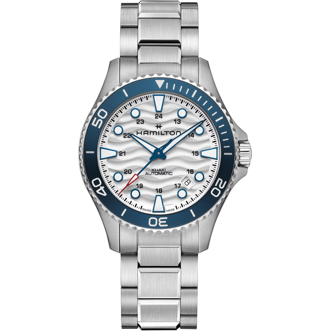 The Hamilton Khaki Navy Scuba Auto 40mm Watch by Hamilton Watch features a stainless steel case, silver and white dial, blue bezel with blue accents, metal link bracelet, date window at 4 o’clock, large hour markers, and three hands.