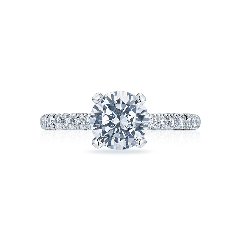 This engagement ring showcases a large round brilliant diamond in a Tacori Petite Crescent Platinum setting, featuring a band adorned with smaller diamonds, expertly crafted by Tacori gemologists.