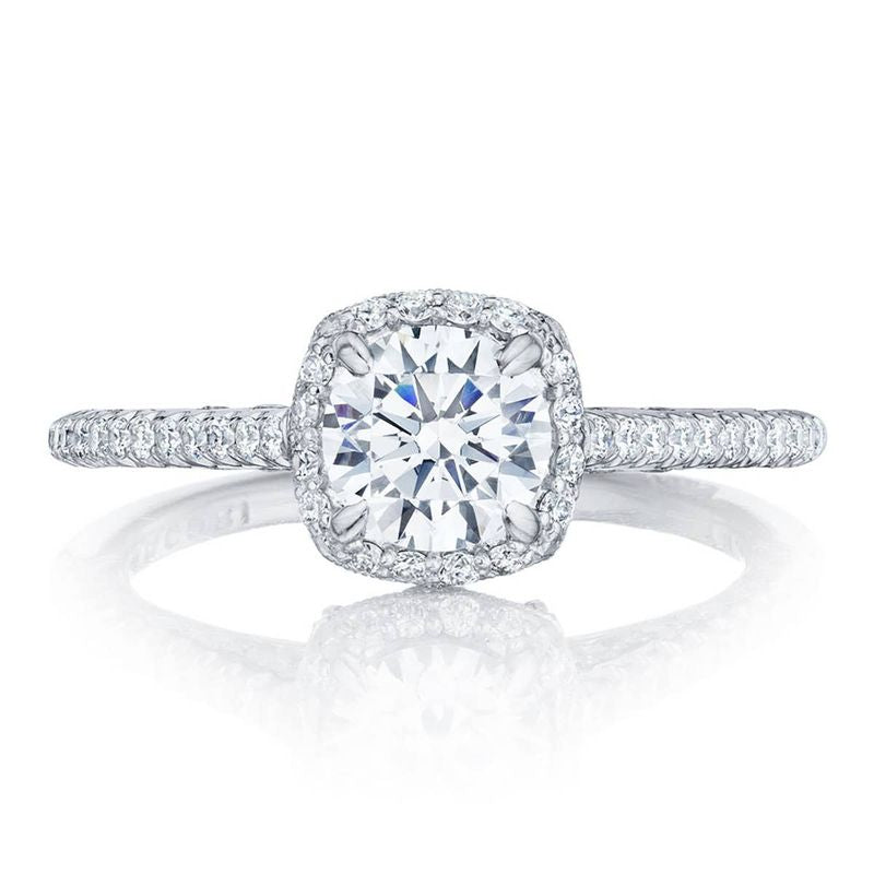Introducing the Tacori Petite Crescent 18K White Gold Cushion Semi Mount Engagement Ring. This stunning piece features a central round, radiant diamond embraced by a sparkling diamond halo. The band, adorned with Tacori's Signature Crescent details and embellished with small diamonds, exudes an aura of elegance and luxury.