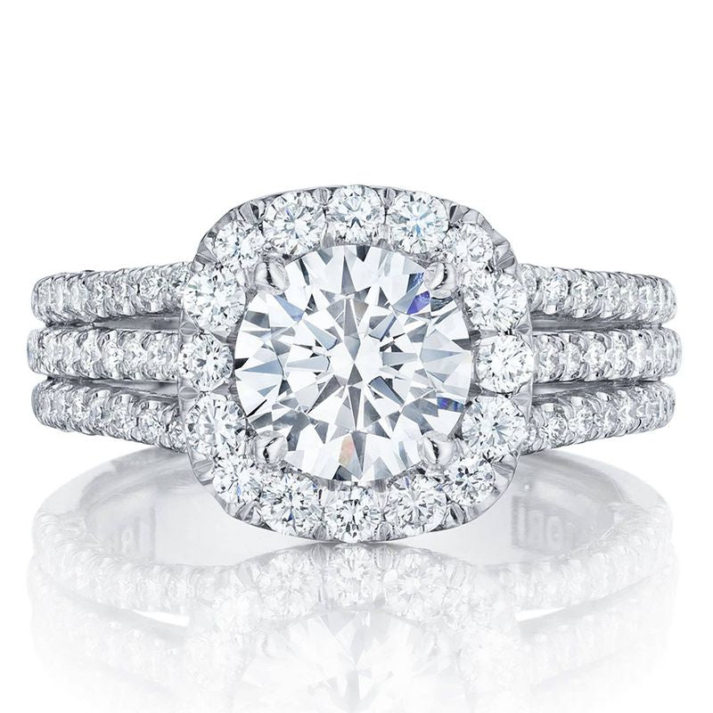 Experience the elegance of Tacori engagement rings with the Tacori Petite Crescent 18K White Gold Cushion Semi Mount Engagement Ring. This exquisite piece features a dazzling round central diamond encircled by a halo of smaller diamonds, complemented by a band adorned with three rows of diamond accents, embodying luxury and sophistication.