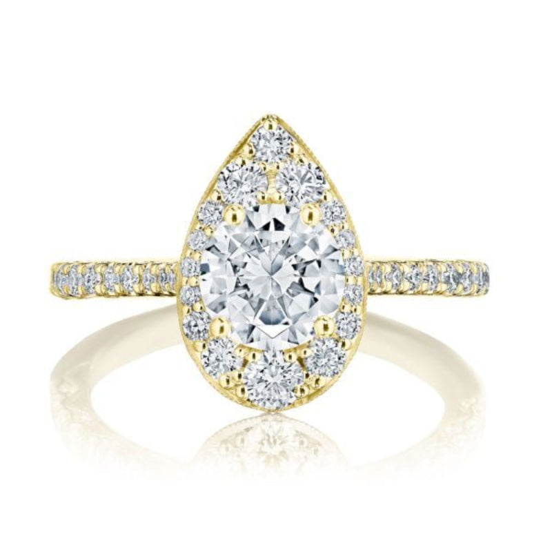 The Tacori Petite Crescent 18K Yellow Gold Round Brilliant Semi Mount with Diamond Band and Halo Engagement Ring showcases a pear-shaped design with a large round diamond centerpiece, encircled by smaller diamonds. The band is embellished with small diamonds and features the Signature Crescent, adding to its elegance and sparkle.