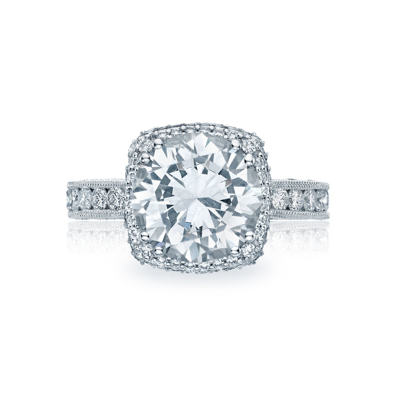 The Tacori Classic Crescent RoyalT Platinum Round Brilliant Semi Mount with Diamond Band and Halo Engagement Ring boasts an exquisite design, featuring a brilliant center stone framed by a halo and set on a band adorned with smaller diamonds that enhance its radiance. The G color diamonds from the Tacori brand elevate the ring's luminous elegance.