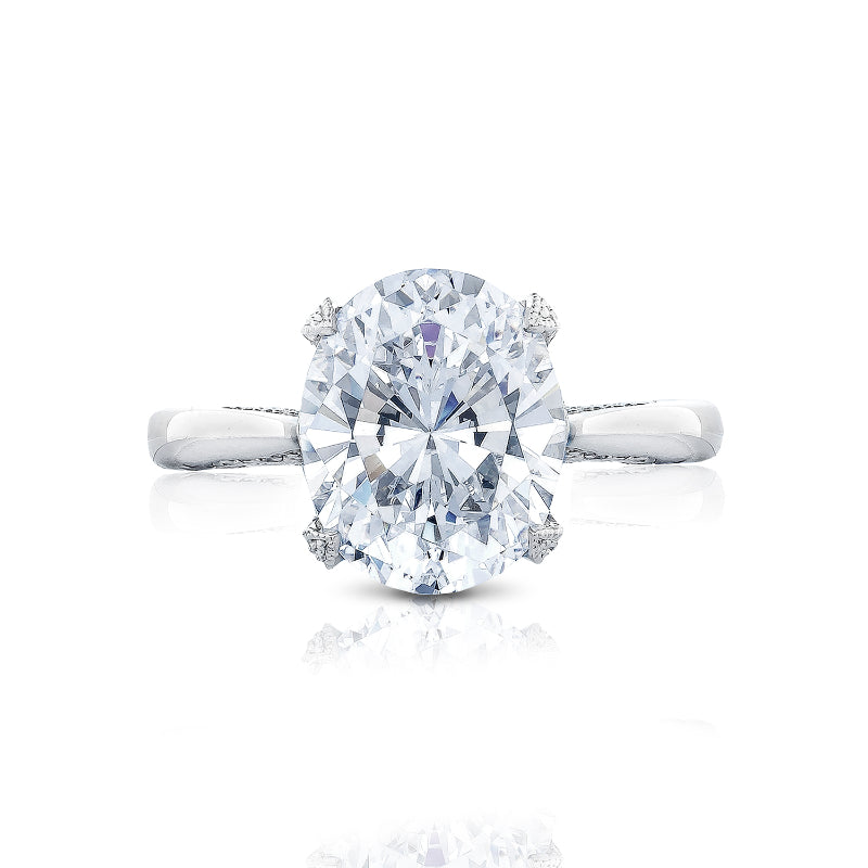 The image captures a detailed view of the Tacori Simply Tacori RoyalT engagement ring, featuring an oval diamond on a classic Cathedral foundation setting. The sleek platinum band is adorned with diamond accents, highlighting the central stone's radiance. This exquisite design exemplifies the craftsmanship of Tacori gemologists on a white background.