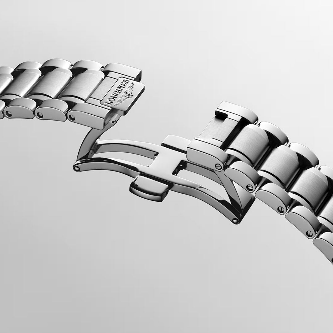 A close-up of the Longines Master Collection Automatic 39mm Watch's stainless steel bracelet with a deployment clasp partially open, highlighting its intricately detailed links and brushed metal finish against a plain background—a testament to the horological craftsmanship embodied by Longines.