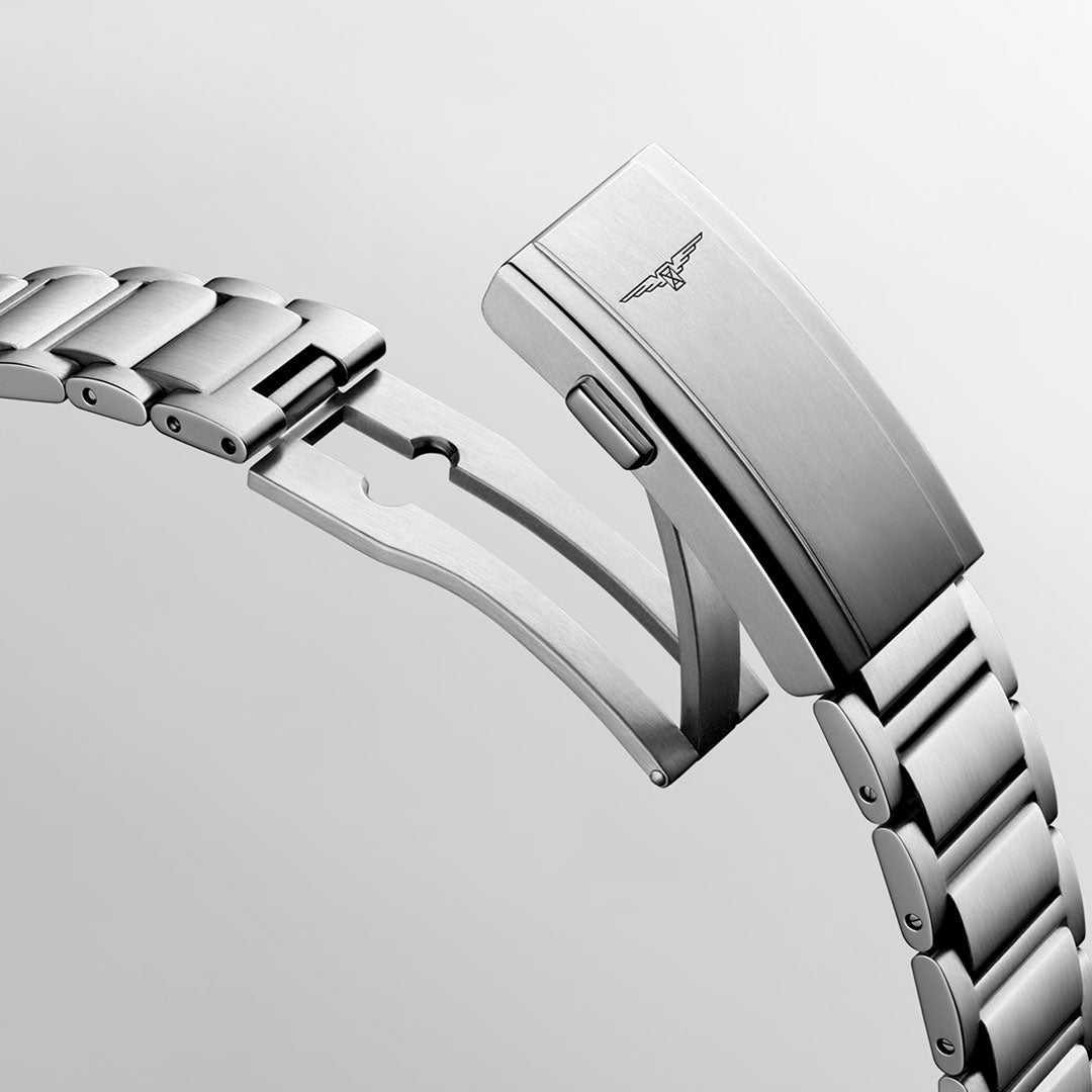 A close-up of the Longines Hydroconquest Automatic 42mm Watch bracelet, displaying a partially open clasp with an engraved winged logo and subtle Swiss Super-Luminova accents, set against a light grey background.