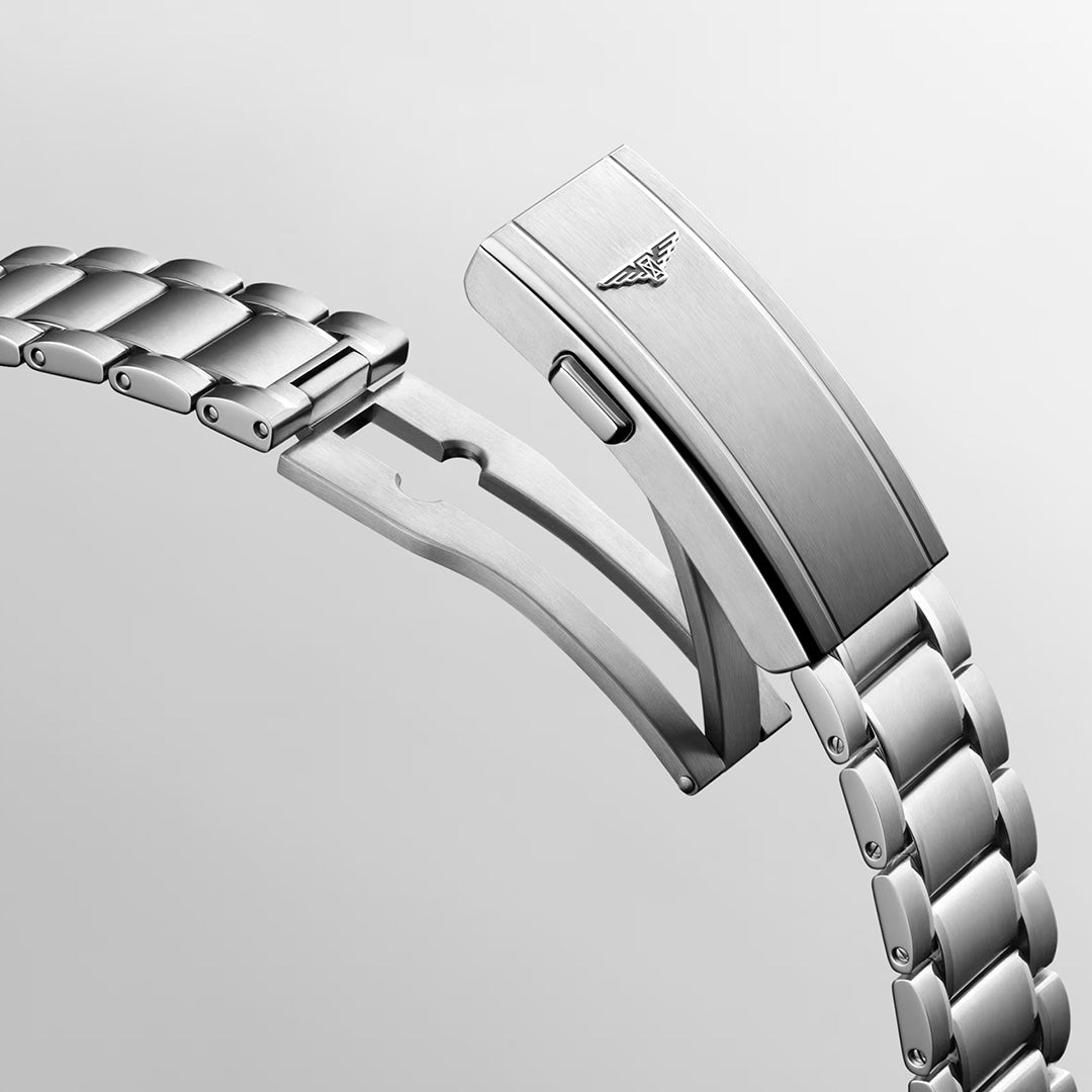 A close-up of a stainless steel watch bracelet with a partially opened clasp, highlighting the sleek design and engraved Longines logo on the clasp of the Longines Spirit Pilot Automatic 39mm Watch against a light gray background.