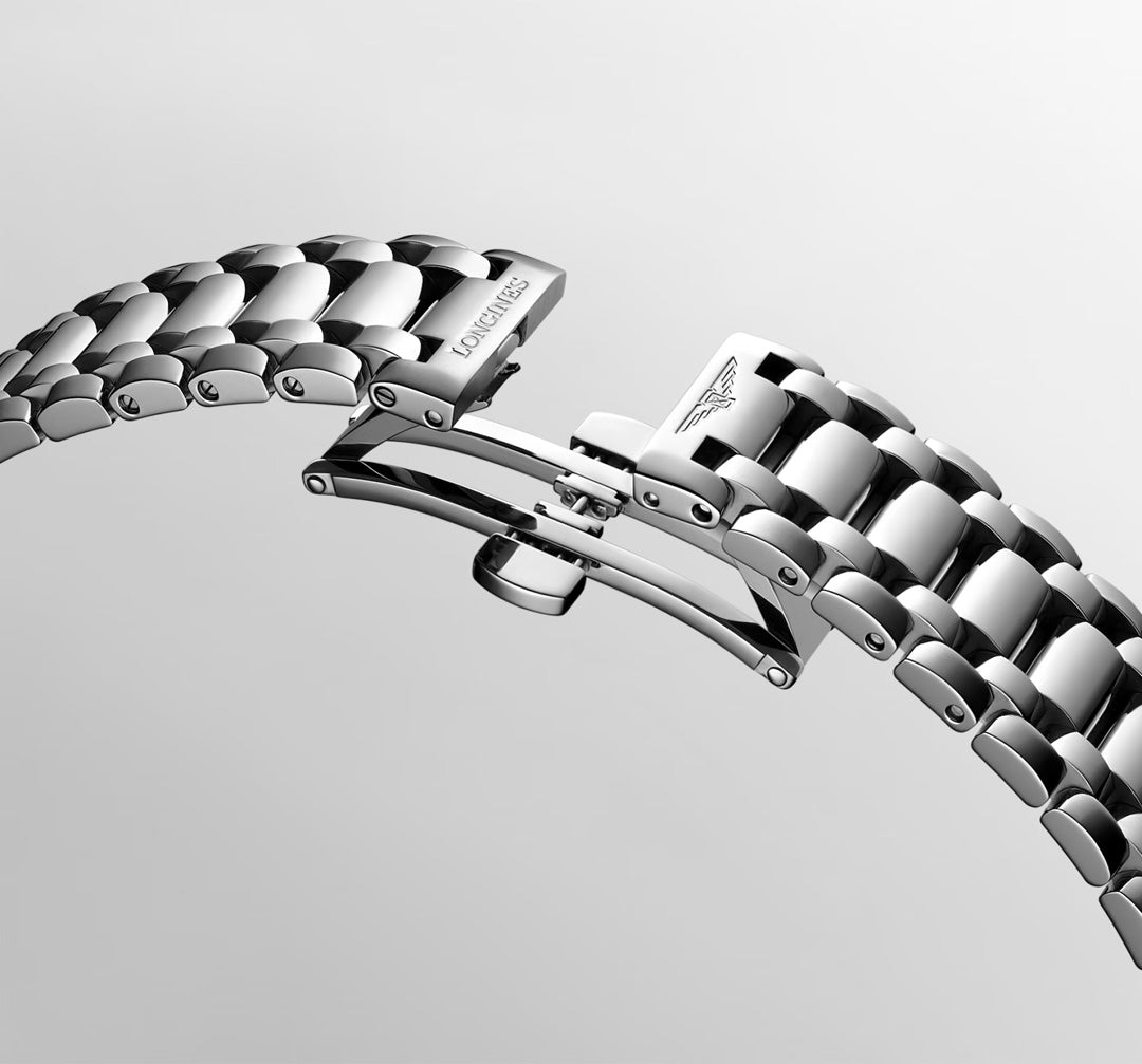 A close-up of the Longines Primaluna Automatic 30mm Watch’s silver metal bracelet with a partially open butterfly clasp, revealing its intricate links and engraved Longines logo, set against a plain light background.