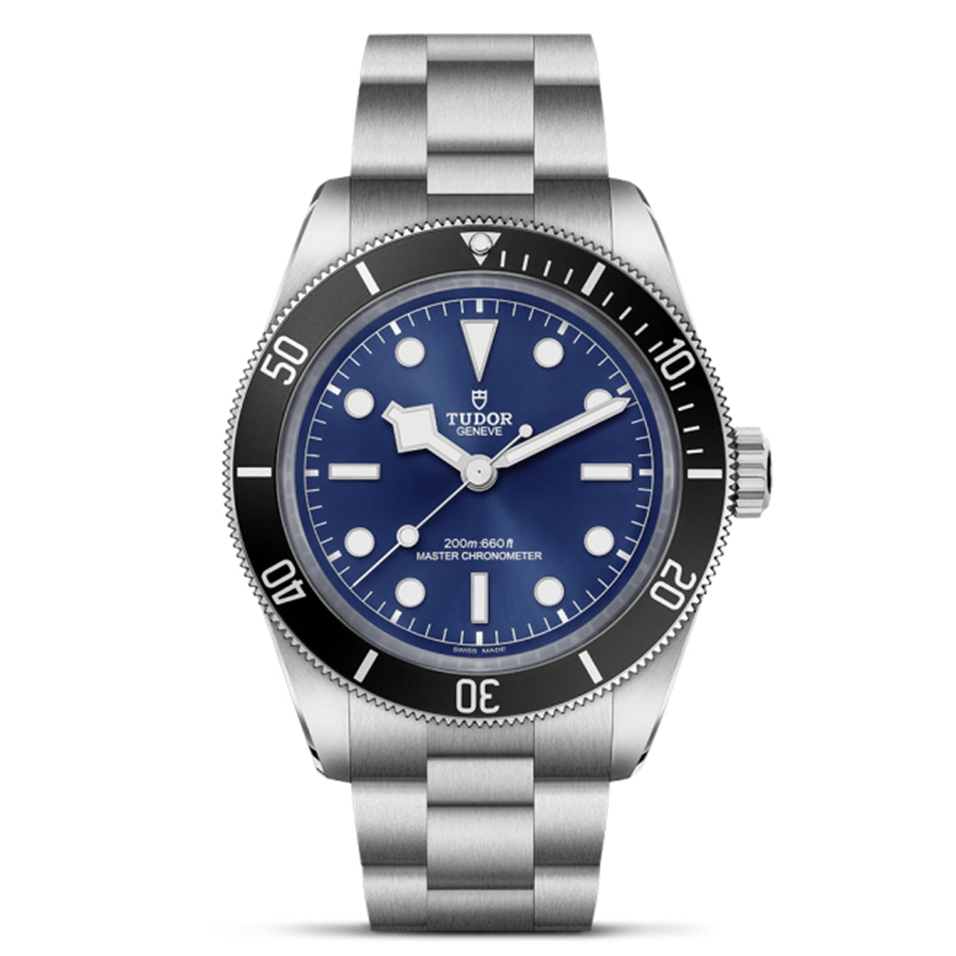 The TUDOR Black Bay 68 is a silver watch featuring a blue face, metal strap, Snowflake hands, and a rotating bezel with white markings. It has luminous hour markers, the brand logo, and "200m=660 ft Master Chronometer" on the dial.