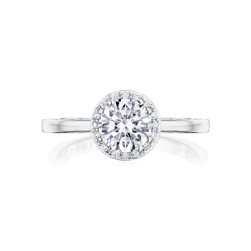 The Tacori Coastal Crescent 14K White Gold Round Brilliant Semi Mount Engagement Ring features a central round-brilliant diamond surrounded by a halo of smaller diamonds. Its slender, smooth band complements the design's elegance, reflecting the craftsmanship of TACORI gemologists.