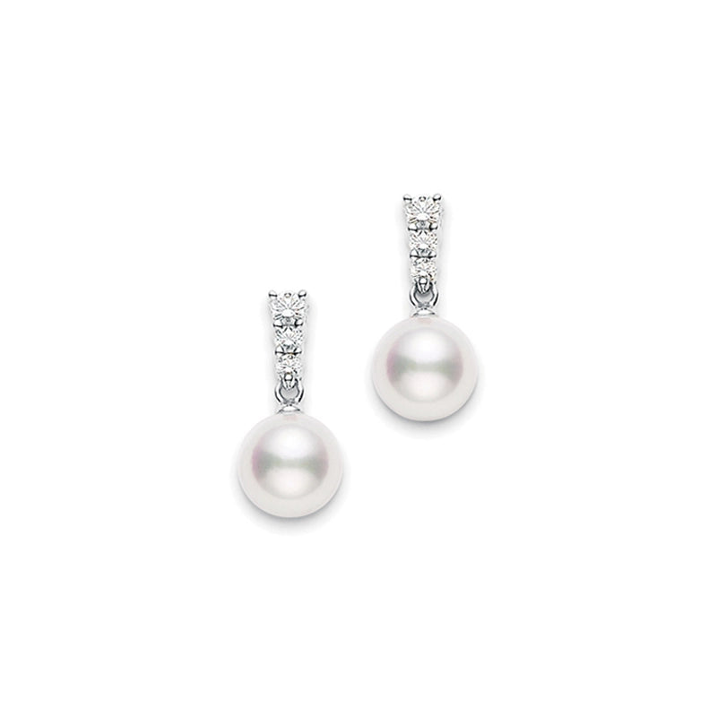 Close-up of Mikimoto's Morning Dew 18K White Gold Drop Earrings showcasing elegant Akoya cultured pearls gracefully suspended from a series of sparkling diamonds. The classic and sophisticated design makes them ideal for formal occasions.