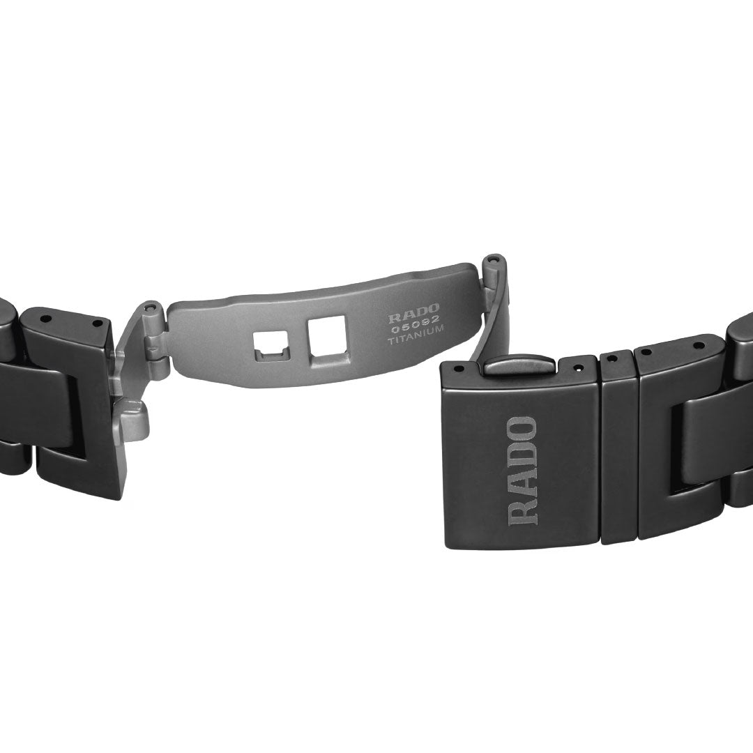 A close-up of an open black RADO Captain Cook High-Tech Ceramic Skeleton Automatic 43mm watch clasp, with the RADO brand engraved on the clasp and inner mechanism, set against a white background.