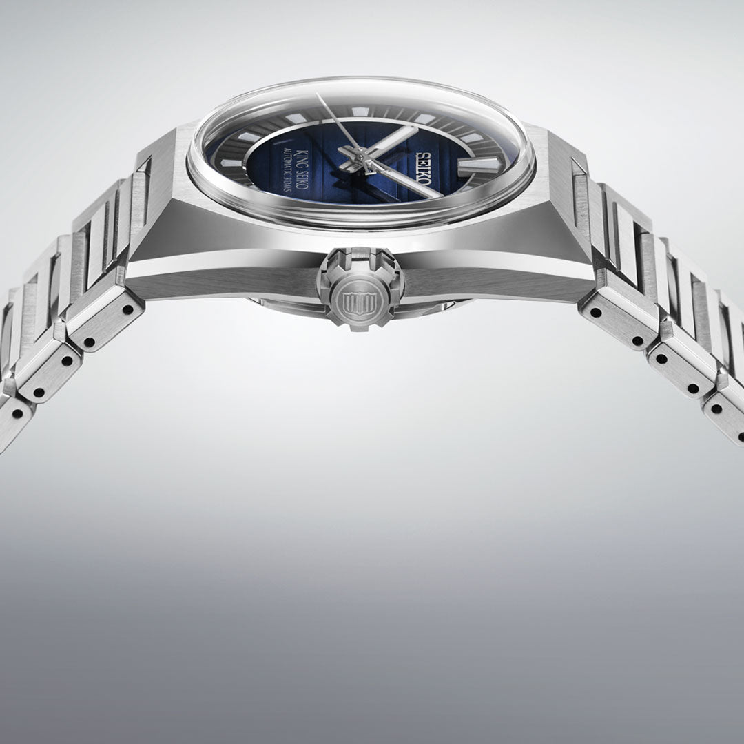 A close-up side view of the Seiko King Seiko Vanac Automatic with Manual Winding 41mm Watch shows its modern stainless steel case, blue dial, and integrated metal bracelet against a plain light gray background.
