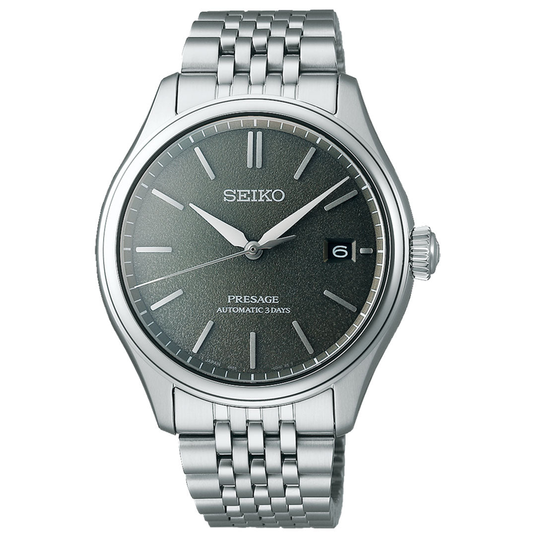 The Seiko Presage Classic Series Automatic With Manual Winding 40.2mm Watch features a silver stainless steel band and an eye-catching green dial. This timepiece is designed with silver hour markers and hands, along with a practical date display at the 3 o'clock position.