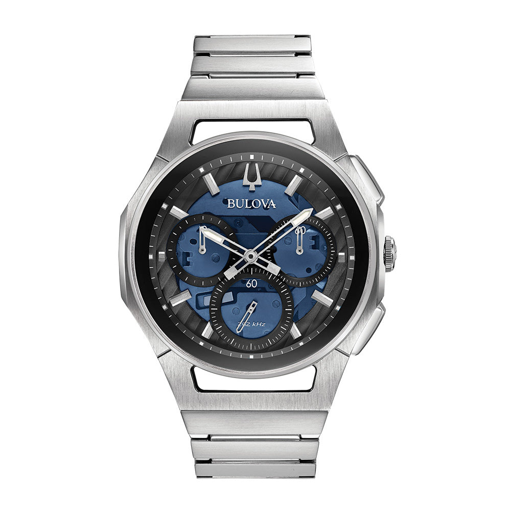 Presenting the Bulova CURV Quartz 44mm Watch, this piece showcases a sleek silver stainless steel band and case. Its striking blue and black chronograph dial is equipped with multiple sub-dials and luminous hands. Powered by high-performance quartz technology, this watch offers a sophisticated, modern aesthetic that embodies the essence of the CURV Collection by Bulova.