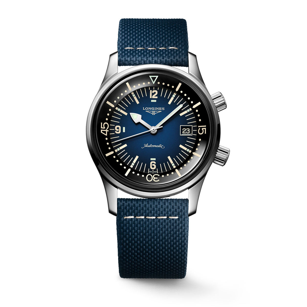 The Longines Legend Diver Automatic 42mm Watch from the Heritage collection is a silver wristwatch that evokes the style of diving watches. It showcases a deep blue dial with beige numerals, two crowns located on the right side, and a date display at 3 o'clock. The watch is completed with a textured blue strap and boasts a sleek, polished finish.