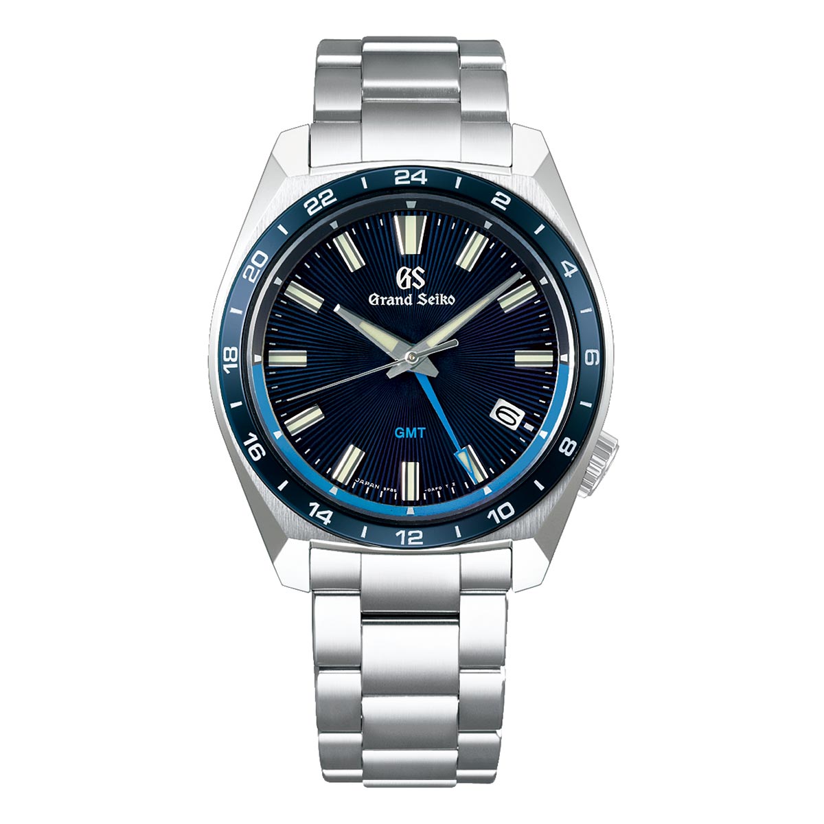 The Grand Seiko Sport Collection 9F Quartz GMT 40mm Watch showcases a blue dial with white hour markers and a 24-hour bezel. It features a stainless steel bracelet and has a date display located at the 4 o'clock position. The luminescent hands and markers guarantee visibility in any lighting conditions.