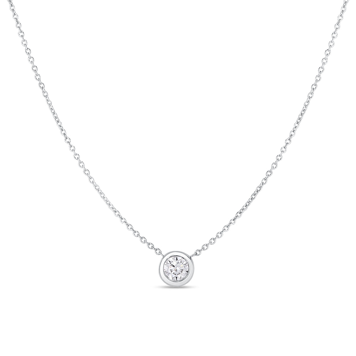 The Roberto Coin 18K White Gold Bezel Set Diamond Necklace showcases a delicate white gold chain with a diamond solitaire pendant in a bezel setting at its center. Its plain white background enhances the simple elegance of this exquisite Roberto Coin jewelry piece.