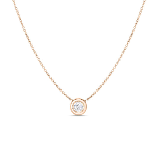 The Roberto Coin 18K Rose Gold Tiny Treasures Single Diamond Bezel Pendant Necklace showcases a single round diamond pendant elegantly set in a bezel. Its fine chain and minimalist design emphasize the sophistication of this piece, making it an ideal choice for both everyday wear and special occasions.