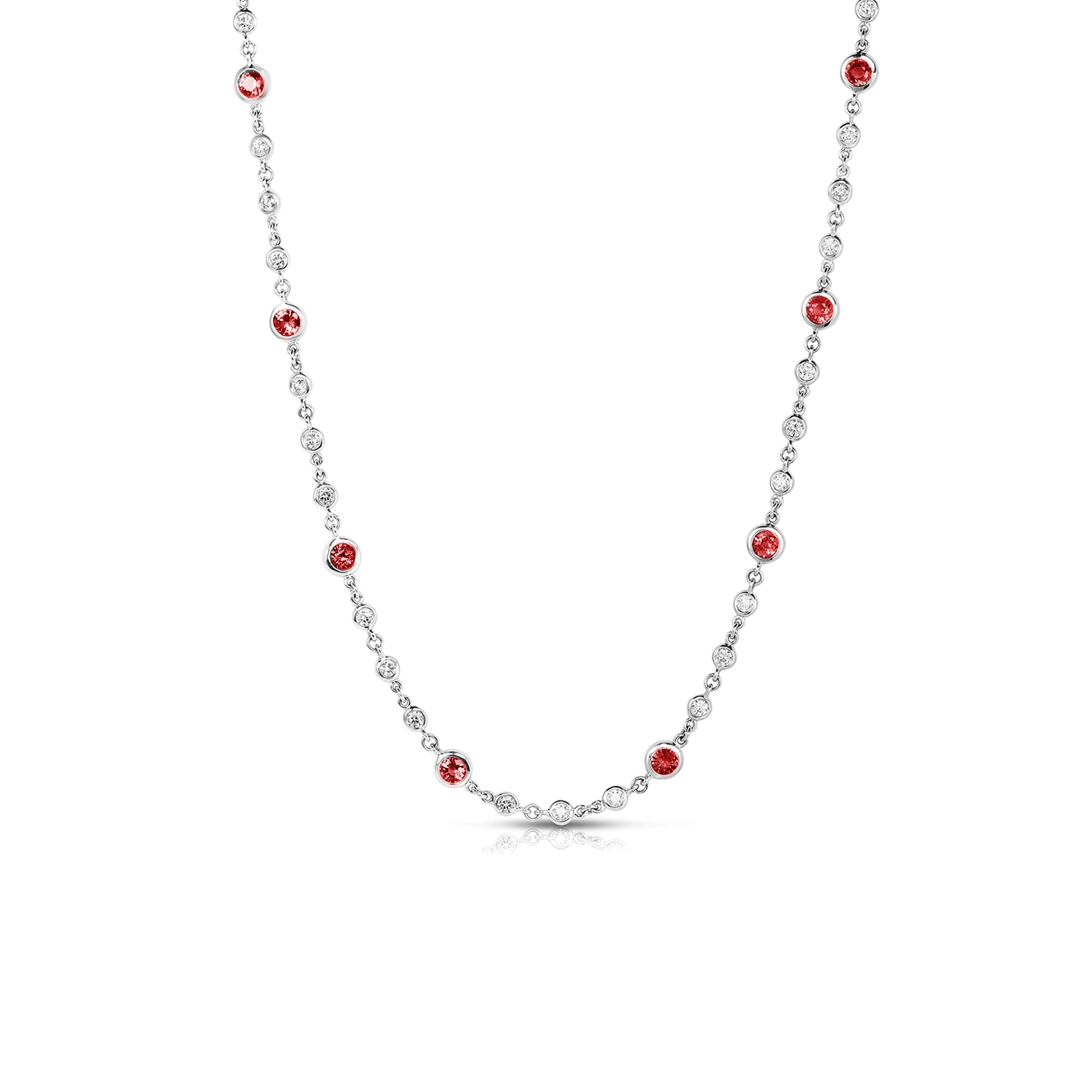 The Roberto Coin Endless necklace, crafted in 18K White Gold, features a stunning symmetrical pattern with alternating small diamonds and ruby settings. It is elegantly displayed on a plain white background.